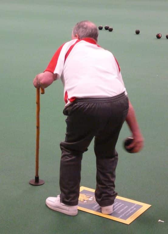 Using walking stick with large ferrule to aid stability - Lawn Bowls Bowling Aids | A Complete Guide To Equipment For Disabled Players